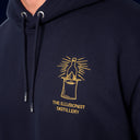The Illusionist Distillery Hoody - Top Hat Logo Close - Up View