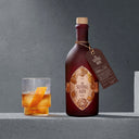 The Sentinel Rum Bottle Next to Rum Cocktail in a Glass